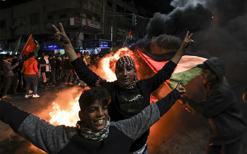 Palestinians celebrate a Jerusalem terror attack that killed seven Israelis near a synagogue, in Gaza City, January 27, 2023. (Mahmud Hams/AFP)