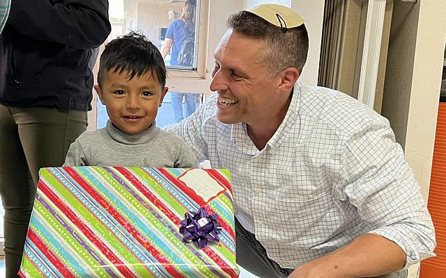 Rabbi Shmuly Yanklowitz with an asylum-seeking child recently removed from ICE detention, who was fortunate enough to have his parents with him.