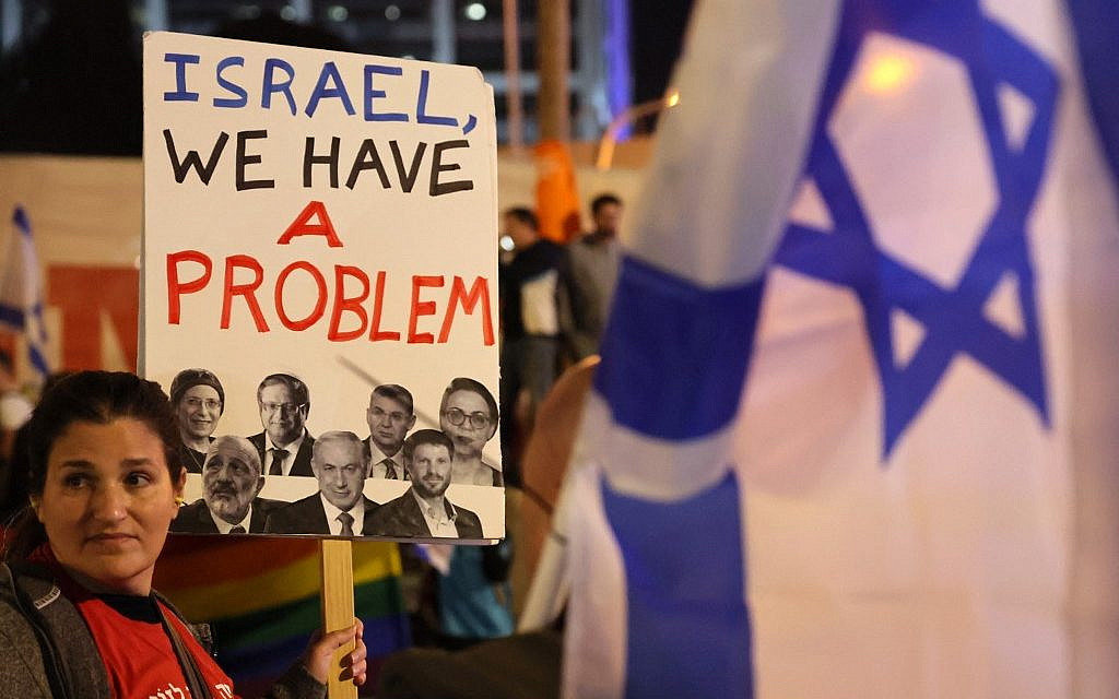 Not that problem. (A protester attends a rally in Tel Aviv against the new government on January 21, 2023. (Photo by JACK GUEZ / AFP))
