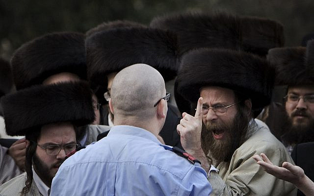 Illustrative: A Haredi demonstrator reacts, in front of a policeman during a demonstration against the opening of a parking garage next to Jerusalem's Old City. Oct. 24, 2009 (AP Photo/ Tara Todras-Whitehill, Files)