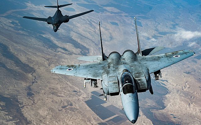 In this photo released by the U.S. Air Force, an Israeli Air Force F-15 Strike Eagle flies in formation with a U.S. Air Force B-1B Lancer over Israel as part of a deterrence flight, on Saturday, October 30, 2021. (US Air Force/Senior Airman Jerreht Harris via AP)