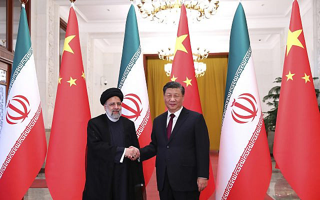 Iranian President Ebrahim Raisi, left, shakes hands with his Chinese counterpart Xi Jinping. Beijing, Tuesday, Feb. 14, 2023. (Iranian Presidency Office via AP)