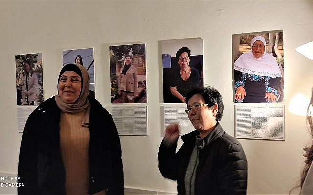 Ramle women pose in front of their photos. (my own work)
