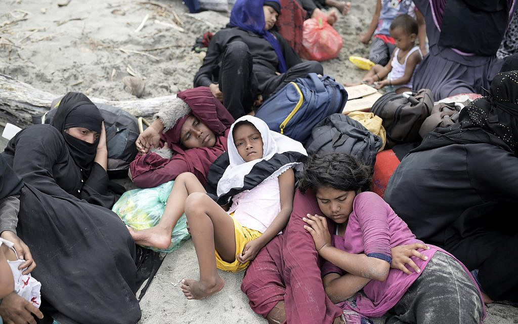 Ethnic Rohingya people rest on Lampanah Leungah beach after landing in Aceh Besar, Aceh province, Indonesia, Thursday, Feb. 16, 2023. A boat carrying dozens of Rohingya Muslims fleeing from refugee camps in Bangladesh landed in Indonesia’s northernmost province of Aceh, local officials said. (AP/Riska Munawarah)