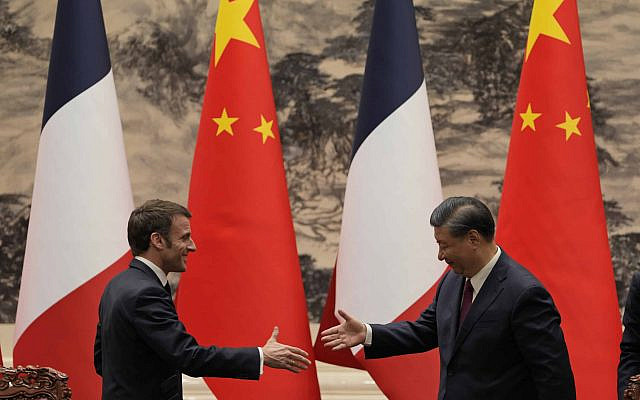 French President Emmanuel Macron, left, shakes hands with Chinese President Xi Jinping after meeting the press at the Great Hall of the People in Beijing, Thursday, April 6, 2023. (AP Photo/Ng Han Guan, Pool)