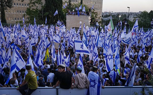Participants wave flags during a rally in support of plans by Prime Minister Benjamin Netanyahu's government to overhaul the judicial system, outside the Knesset in Jerusalem, Thursday, April 27, 2023. (AP Photo/Ohad Zwigenberg)