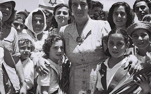 AFTER THE OPENING OF THE TEL AVIV NATHANIA        HIGHWAY, MRS. GOLDA MEIR POSES FOR A PICTURE WITH THE       CHILDREN OF KIBBUTZ SHEFAIM.