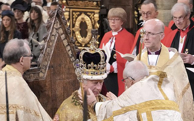 King Charles III sits as he is crowned with St Edward's Crown by The Archbishop of Canterbury the Most Reverend Justin Welby during the coronation ceremony at Westminster Abbey, London, on May 6, 2023. (Jonathan Brady/Pool Photo via AP)
