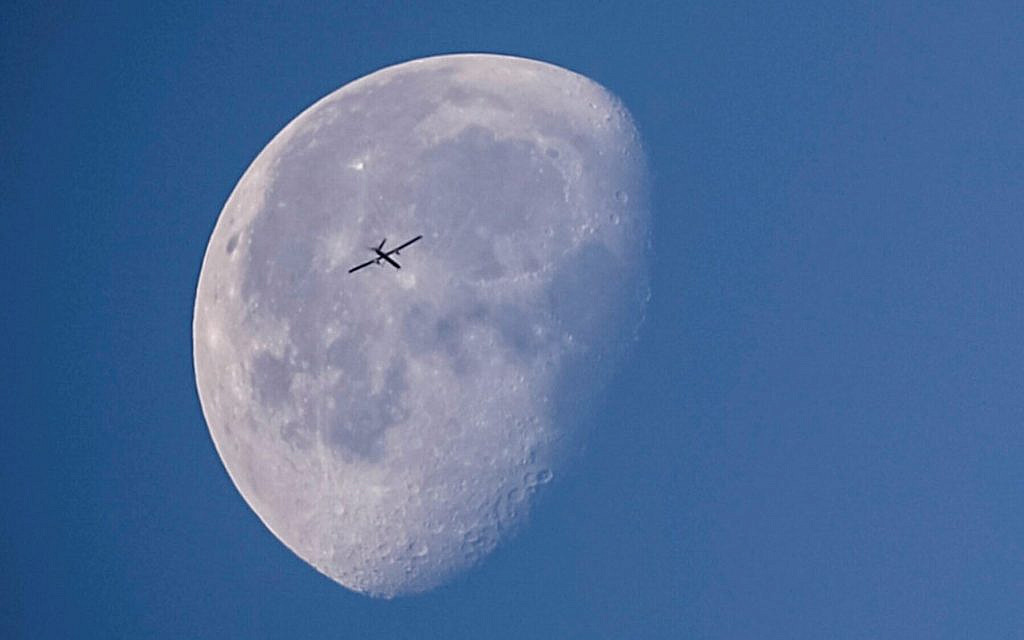 An Israeli reconnaissance unmanned aerial vehicle, backdropped by the moon, flies over Gaza City on May 10, 2023. (ANAS BABA / AFP)