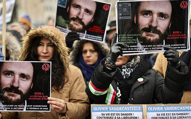 People at a demonstration in Brussels hold placards calling to free Belgian aid worker Olivier Vandecasteele, who was detained in Iran. Sunday, Jan. 22, 2023. (AP Photo/Olivier Matthys)