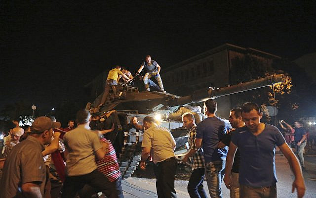 Tanks move into position as people attempt to stop them, in Ankara, Turkey, during the coup attempt, late Friday, July 15, 2016. (AP Photo/Burhan Ozbilici)