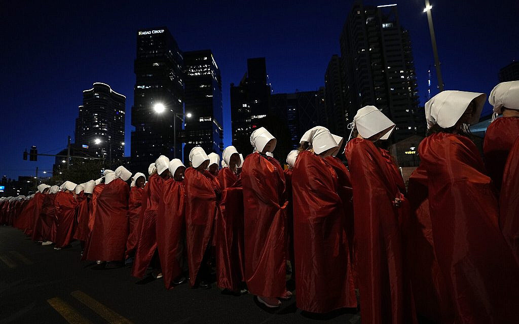 Protesters supporting women's rights dressed as characters from "The Handmaid's Tale" TV series attend a protest against the government's plans to overhaul the judicial system, Tel Aviv, Israel, March 11, 2023. (AP/Ohad Zwigenberg)