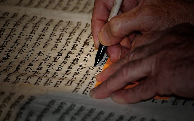 Illustrative. Repairing a 300-year-old Torah scroll, letter by letter. (iStock)