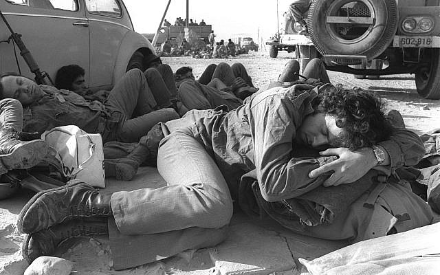 IDF soldiers catching a few minutes of sleep during a stop-over in Sinai, during the Yom Kippur War. (Government Press Office Photo Archive)