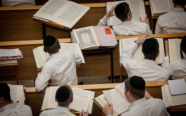 Yeshiva students study at the Kamenitz Yeshiva, in Jerusalem on August 22, 2023. (Chaim Goldberg/Flash90)