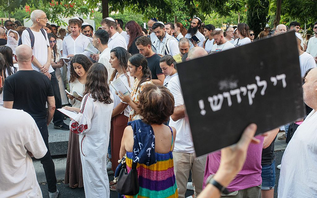 Jews pray while activists protest against gender segregation in the public space during a public prayer on Dizengoff Square in Tel Aviv, on Yom Kippur, the Day of Atonement, and the holiest of Jewish holidays, September 25, 2023. (Itai Ron/Flash90)