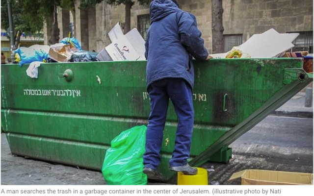 A man searches the trash in a garbage container in the center of Jerusalem. (illustrative photo by Nati
Shohat/Flash90)