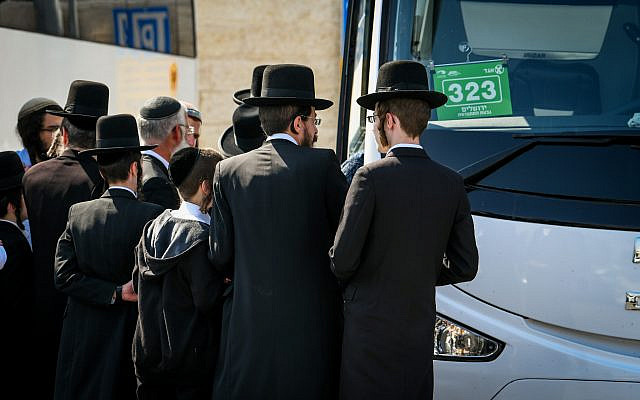 Illustrative: Ultra-Orthodox men board the bus to the Lag B'omer festival in Meron, in Jerusalem, on May 8, 2023. (Arie Leib Abrams/ Flash90)