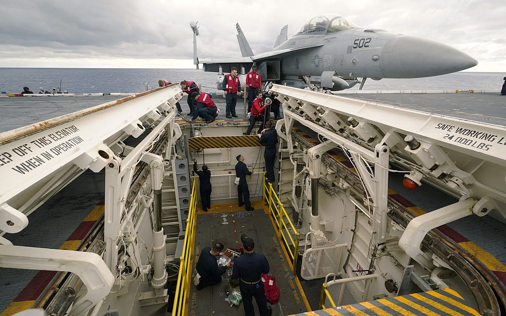 FILE - Weapons personnel work on a weapons elevator on the flight deck of the nuclear powered aircraft carrier USS Gerald R. Ford Thursday, Oct. 6, 2022, off the Virginia Coast. (AP Photo/Steve Helber, File)