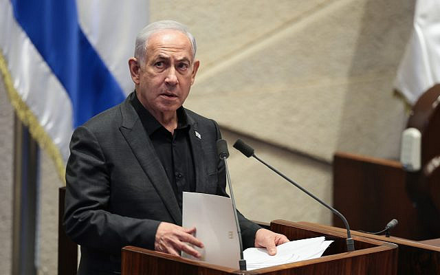Prime Minister Benjamin Netanyahu speaks at a special Knesset plenum session presenting the new emergency government, in Jerusalem, October 12, 2023. (Noam Revkin Fenton/Flash90)