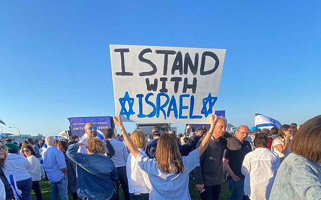 Standing at an organised peaceful Israel rally in Sydney, Australia, holding an 'I stand with Israel' poster.