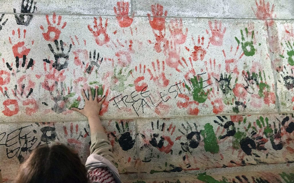 A protester makes hand prints on the wall of Union Station building during a pro-Palestinian demonstration asking for a ceasefire in Gaza in Washington, Friday, Nov. 17, 2023. (AP/Jose Luis Magana)