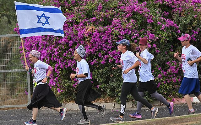 Women run for the release of Israelis held kidnapped by Hamas terrorists in Gaza, in Katsrin, on November 17, 2023. (Michael Giladi/Flash90)