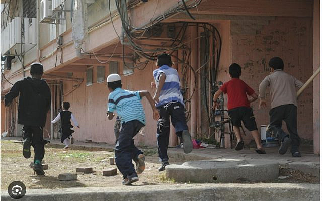 Children run toward a bomb shelter in the southern Israeli town of Kiryat Malachi during a November 2012 military operation in Gaza, known as Pillar of Defense. (Yuval Haker/Israel Defense Forces/via The Times of Israel)