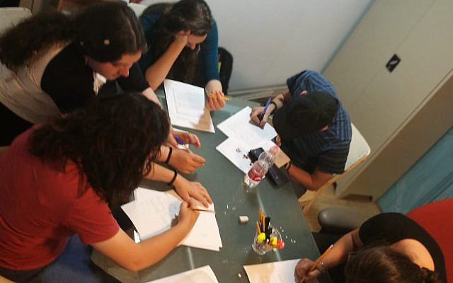 Doing schoolwork in small groups is part of Beit Daniella's program for troubled teens at the Havat Harei Yehuda riding stable and dog kennel, west of Jerusalem. (Courtesy, Beit Daniella, via The Times of Israel)