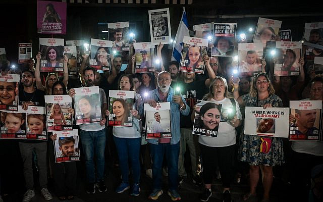 Families of Israelis held hostage by Hamas terrorists in Gaza hold up photographs of their abducted relatives, at 'Hostage Square,' outside the Art Museum of Tel Aviv, October 21, 2023. (Avshalom Sassoni/ Flash90)