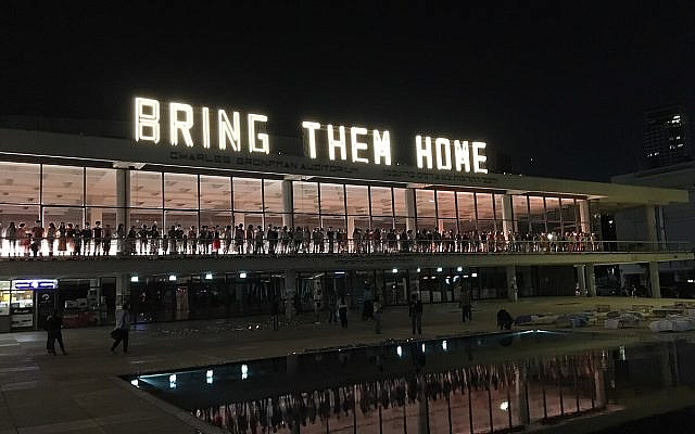 Bring Them Home. A giant lights sign, by artist Nadav Barnea, at Charles Bronfman Auditorium, Heichal Hatarbut, Tel Aviv. (Wikimedia Commons)