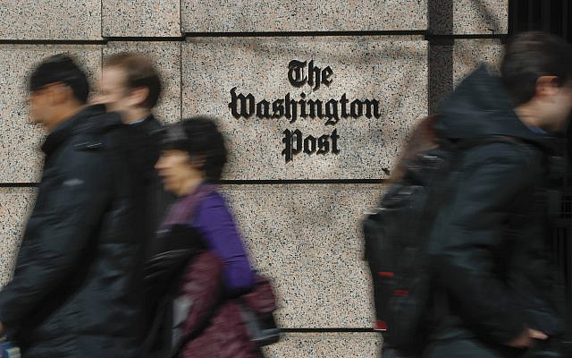 People walk by the One Franklin Square Building, home of The Washington Post newspaper, in downtown Washington on February 21, 2019. (Pablo Martinez Monsivais/AP)