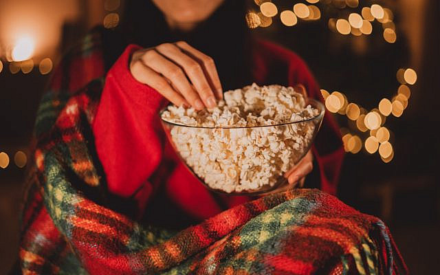 Watching a movie during the Christmas season, with popcorn. (iStock)