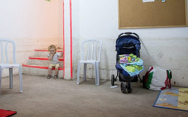 A young girl inside a bomb shelter in Tel Aviv as rocket barrages from Gaza rain down on the city, on May 16, 2021. (Miriam Alster/Flash90)
