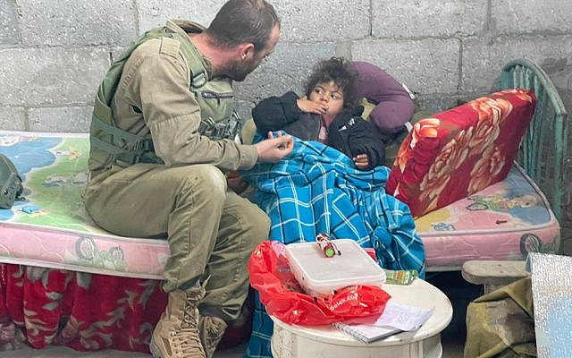IDF reservists of the 646th Brigade treat a Gazan child in the central Gaza Strip, December 2023. (IDF's 646th Brigade)