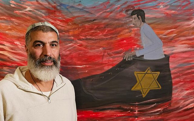 Artist Shai Azoulay stands in front of his painting "Bigger Than Me," part of an exhibit at the Museum of Holocaust Art at Yad Vashem in Jerusalem. (Courtesy Yad Vashem)