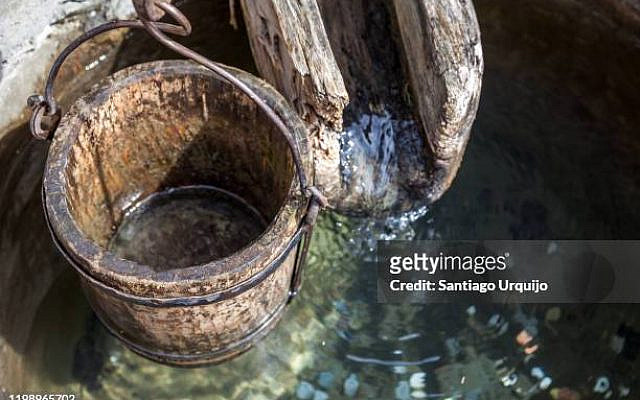 Wooden bucket and gutter on a well, Barsana, Maramures, Romania