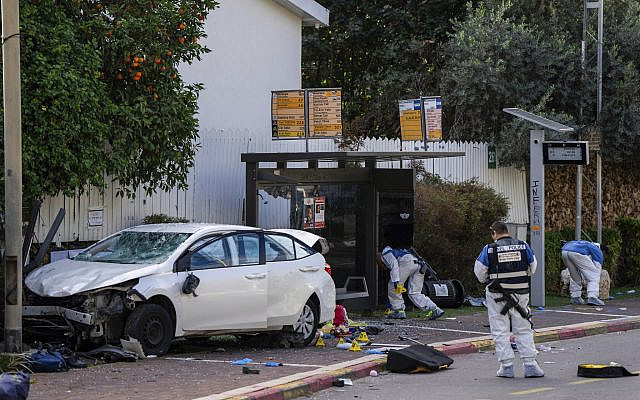 Israeli security forces work at the site of a Palestinian car-ramming and stabbing attack at a bus stop, in Ra'anana, January 15, 2024. (AP Photo/Oded Balilty)