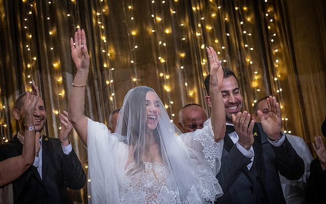 One of ten Israeli couples with a member serving in the IDF that took part in a mass wedding ceremony, part of Chabad of Savyon’s “Marrying the Warriors”, in Tel Aviv Port, March 5, 2024. (Chaim Goldberg/Flash90)