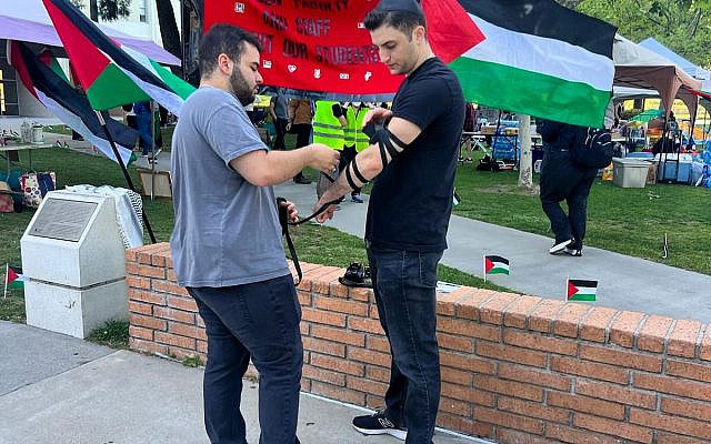 At CSUN University students helped each other put on Teffilin against the backdrop of hateful rhetoric. Image Chabad CSUN