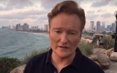 Conan O'Brien visits Jaffa, with the Tel Aviv skyline in the background, on August 26, 2017. (Screen capture: Facebook)
