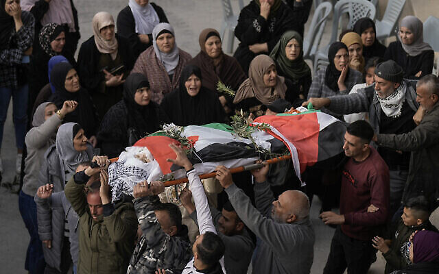 تصویر: فلسطینیان در حال حمل پیکر جنا ذاکرنا، ۱۶ ساله، در مراسم تشییع وی در جنین، کرانه باختری، ۱۲ دسامبر ۲۰۲۲. (AP Photo/Majdi Mohammed)