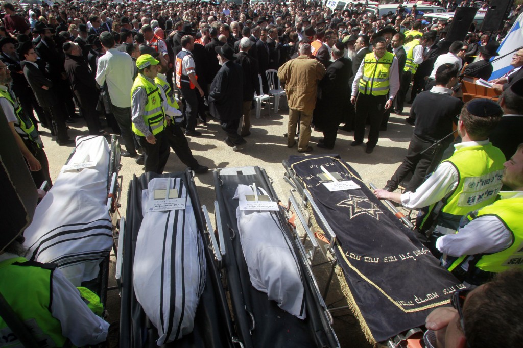 The bodies of the Toulouse Jewish school shooting victims, shrouded in talitot, prior to burial at the Givat Shaul cemetery in Jerusalem on Wednesday. (photo credit: Uri Lenz/Flash 90)