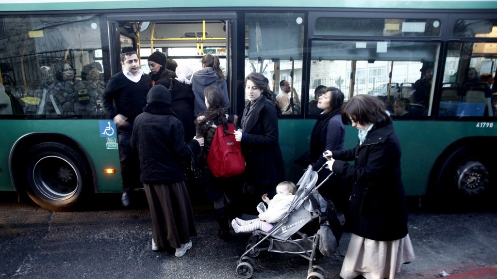 Orthodox women enter a gender-segregated bus through the back door (photo credit: Uri Lenz/Flash90)