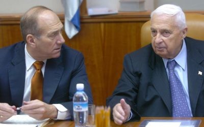 Ehud Olmert and Ariel Sharon, at a 2004 cabinet meeting. (photo credit: Sharon Perry/Flash 90/File.