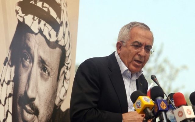 Palestinian Prime Minister Salam Fayyad speaks underneath a poster of a young Yasser Arafat (photo credit: Issam Rimawi/Flash90)
