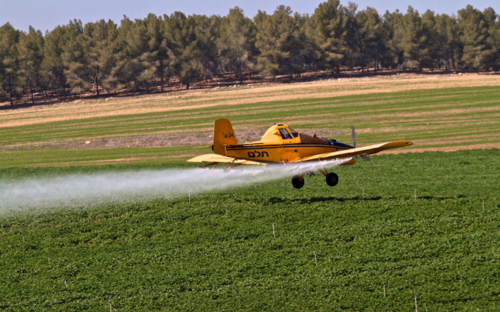 An agricultural aircraft sprays crops with fertilizers, pesticides, and fungicides. (photo credit: Doron Horowitz/Flash90)