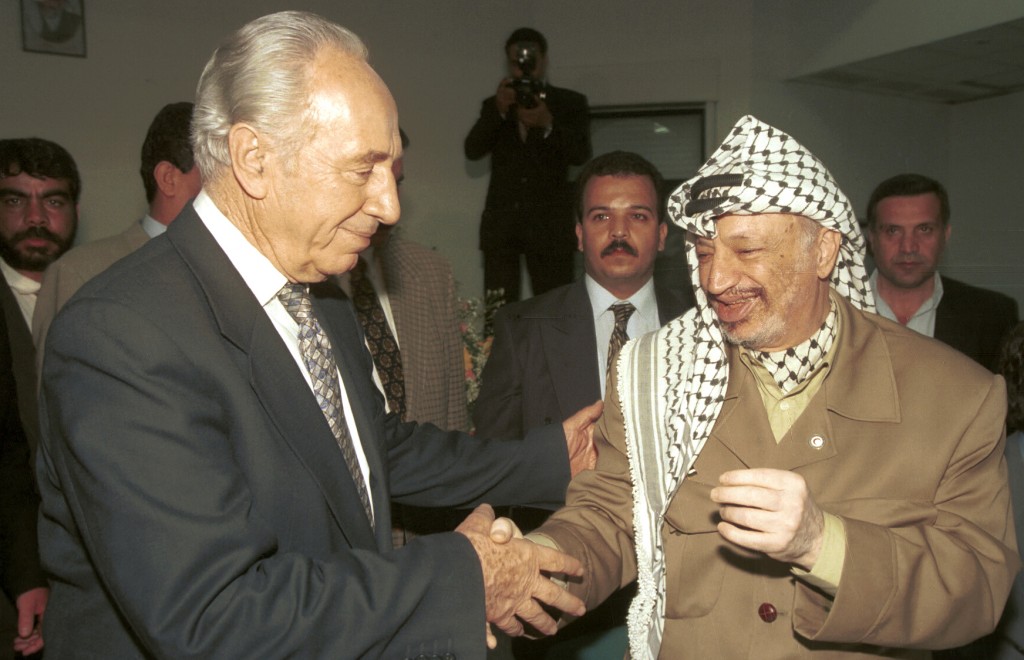 Shimon Peres meets with Palestinian leader Yasser Arafat in Ramallah, May 14, 1997. (photo credit: Flash90)