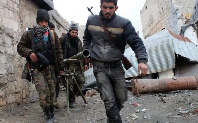 Des rebelles syriens transportent un lance-roquettes lors de combats contre l'armée, le 27 janvier 2014 à Alep 
(Crédit : AFP/Salah Al-Ashkar)