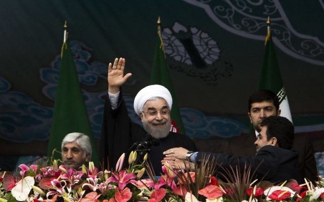 Le président iranien Hassan Rouhani saluant la foule lors du rassemblement célébrant le 36ème anniversaire de la révolution islamique le 11 février 2015 (Crédit : BEHROUZ MEHRI / AFP)